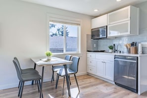 The dining area and kitchen offer an enjoyable, seamless space for cooking and gathering.