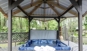Pergola covered Adult hot tub is perfect for weary travelers, string lights deck