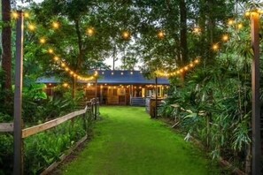 String lights connect the primary home and the entire backyard to the event barn