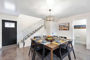 Seating for 8 around the table, plus 3 more at the nearby bar.
