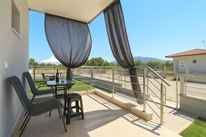 Enjoy a quiet sunrise with coffee on your balcony, overlooking tranquil olive groves.