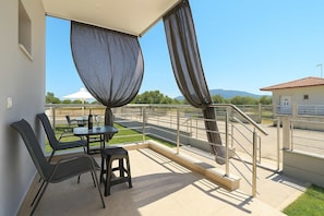 Enjoy a quiet sunrise with coffee on your balcony, overlooking tranquil olive groves.