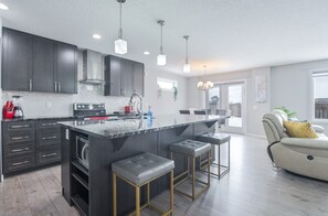 Fully equipped luxury kitchen with premium appliances and ample space for cooking and dining