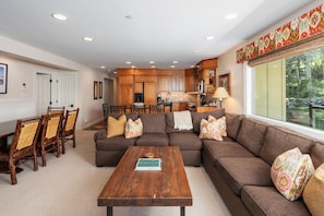 Open living space featuring oversized sectional, live-edge coffee table, and gourmet kitchen. Dining for 6 and large windows with mountain views make this perfect for groups.