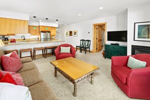 Open living space featuring a comfortable seating area and gourmet kitchen. Dining for 6 at the granite counter.