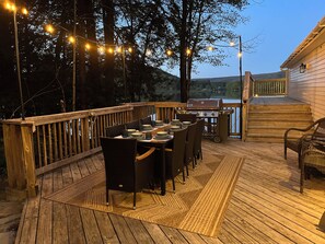 Outdoor dining area, string lights, Weber Grill, overlooking lake