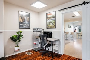 Workspace includes comfortable office chair, monitor, and Wi-fi printer.