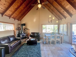 Living Room 1 with Smart TV, fireplace, dining table, love seats & family games