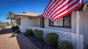 Front of house with nice protected walkway to front door.
