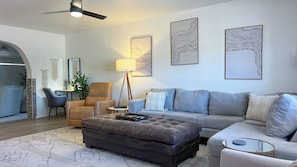 Living room with desk area tucked in the corner.