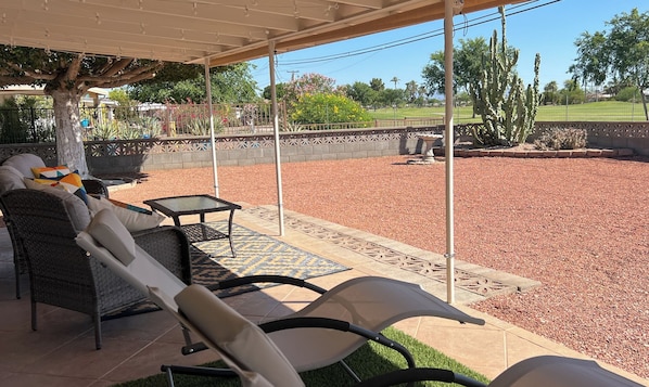 Golf course views! Outdoor patio has roll down sun shades.