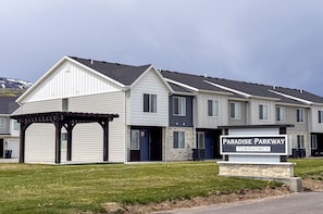 Beautifully designed Paradise Parkway Townhomes with modern architecture, pergola seating, and mountain views.