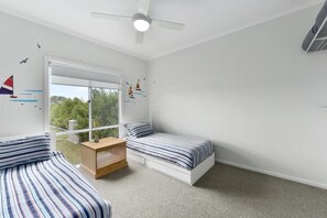 Fun twin single beds with open wardrobe storage