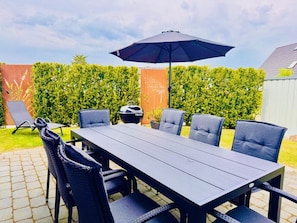 große Terrasse mit Holzkohlegrill und Liege