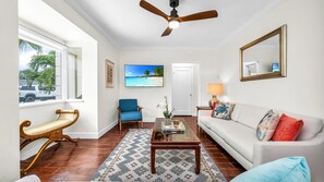 Step into a bright and breezy living space filled with coastal charm—this thoughtfully styled West Palm Beach home features a cozy seating area, smart TV, and seamless flow to the dining room and backyard oasis. Ideal for relaxing after a day of sun & sea.