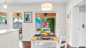 Enjoy effortless indoor-outdoor dining in this sun-filled space featuring a cozy breakfast nook, modern pendant lighting, and direct access to the lush backyard patio—perfect for morning coffee or evening meals under the stars.