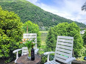 Green, Shrub, Outdoor Furniture, Garden, Spring, Outdoor Table, Mountain Range, Chair, Landscaping