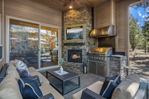 The patio also has a grill and a gas fireplace. There is also a fan.
