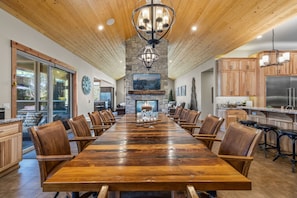 The dining room table offers 12 seats and is right next to the fireplace.