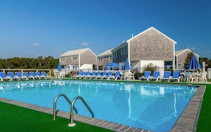 Dive into vacation mode with a refreshing swim surrounded by classic coastal cottages and blue skies overhead.