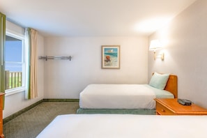 Wake to coastal light and soft sea breezes in a room designed for calm and connection.