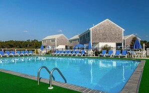 Dive into vacation mode with a refreshing swim surrounded by classic coastal cottages and blue skies overhead.