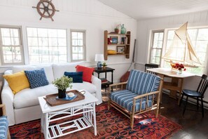 Cheerful hues and nautical touches create a welcoming retreat made for lingering with good books and better company.