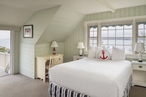 Nautical touches and soft light fill this airy bedroom with cozy charm and a sense of seaside ease.