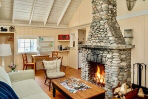 Gather near the warmth of the stone hearth, where stories are shared beneath lofty ceilings and rustic beams.