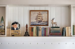 Lined with seafaring stories and nautical curios, this cozy shelf brings a little maritime wonder to your stay.
