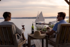 Unwind as the sky softens and sails drift by—an evening steeped in connection and quiet coastal beauty.