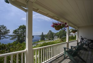 Morning coffee or evening quiet—this porch perch offers harbor views and the peaceful rhythm of life by the sea.