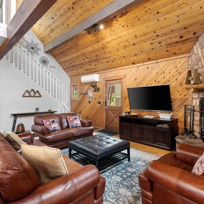 Living area with leather seating, fireplace, and Smart TV