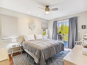 Elegant and comfortable bedroom with soft linens, a ceiling fan, and peaceful decor for a restful night’s sleep.