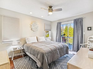 Elegant and comfortable bedroom with soft linens, a ceiling fan, and peaceful decor for a restful night’s sleep.