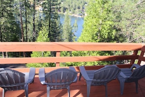 Patio deck with 4 + 4 chairs overlooking the lake and green forest