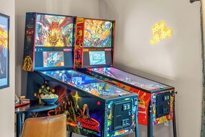 Enjoy arcade fun with pinball, stylish seating, and a vibrant atmosphere!