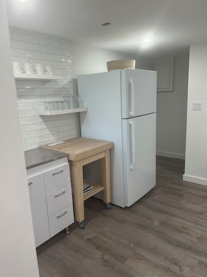 From entryway stairs leading into kitchen/dining area