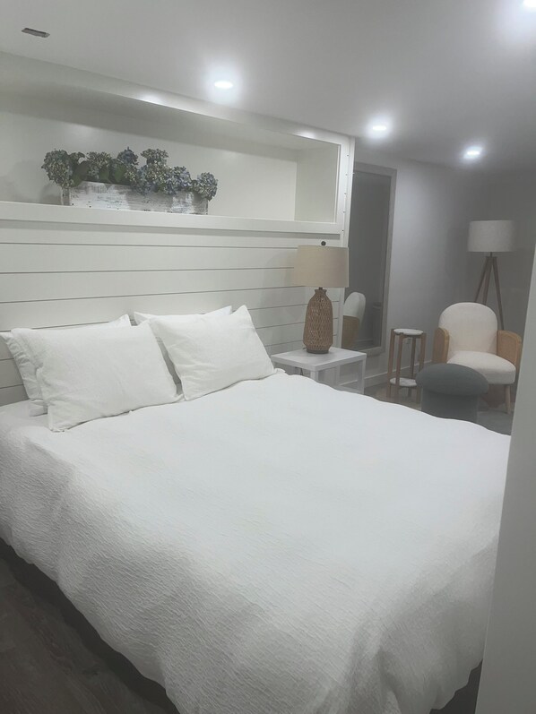 Queen master Bedroom has closet and two bureaus mirror and seating area