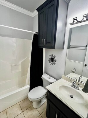 Guest bathroom with tub/ shower combo—your personal spa-like retreat, perfect for unwinding after a day of adventure.

