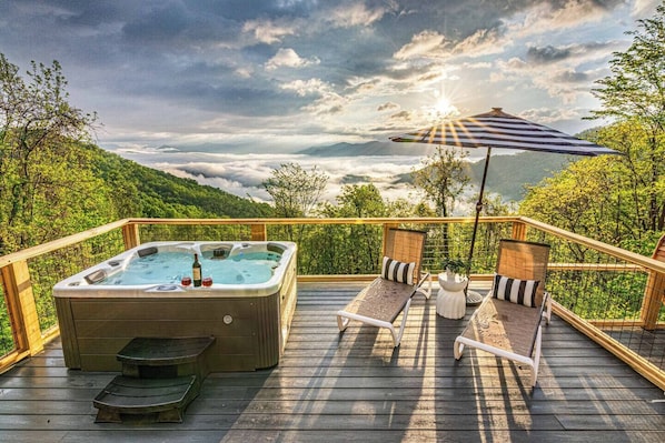 Relax in style with this outdoor hot tub, perfectly placed to offer stunning views of the surrounding landscape while providing a soothing soak in the warmth of bubbling waters.