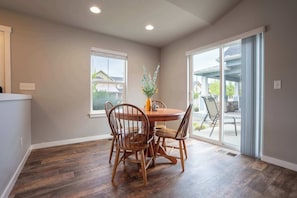 Share meals, game nights, or morning coffee in the bright dining area, just steps from the patio for easy outdoor access.