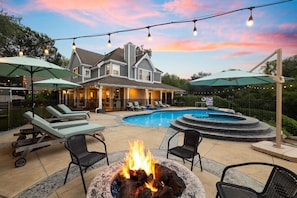 Imagine cozy evenings chatting around the fire pit under the soft glow of string lights, with the inviting pool and spa just moments away. Relaxation and good times are waiting for you.