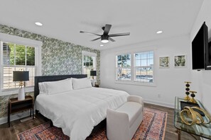 Oakwood Oasis: Primary Bedroom with Ensuite Bathroom. Overlooking the Backyard Putting Green.
