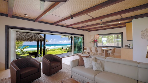 Main living and dining area with views of the ocean and the back