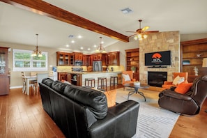 Open-concept living with a large fireplace, gourmet kitchen, and plenty of room to relax with guests