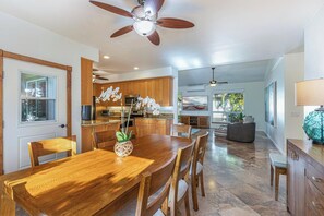 Dining room has ample lighting and flows into kitchen