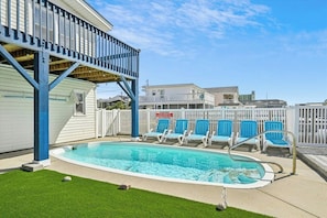 Take a cool dip in the sparkling pool after a fun day at the beach.