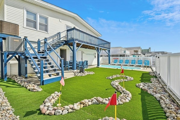 Practice golf on the backyard putting green.