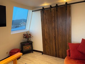 private door in queen bedroom with electric fireplace